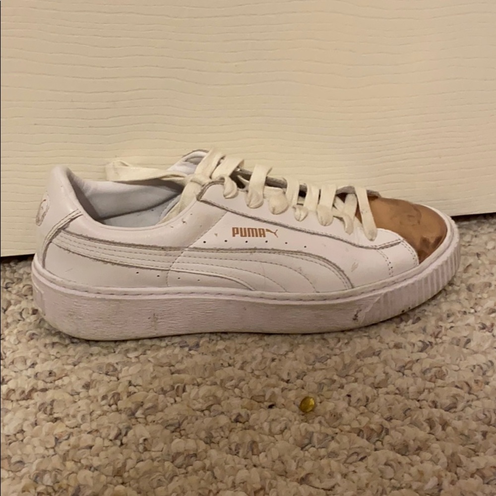 White puma shoes with a gold toe